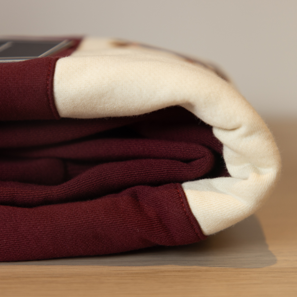 folded burgundy maroom fleece sweatshirt